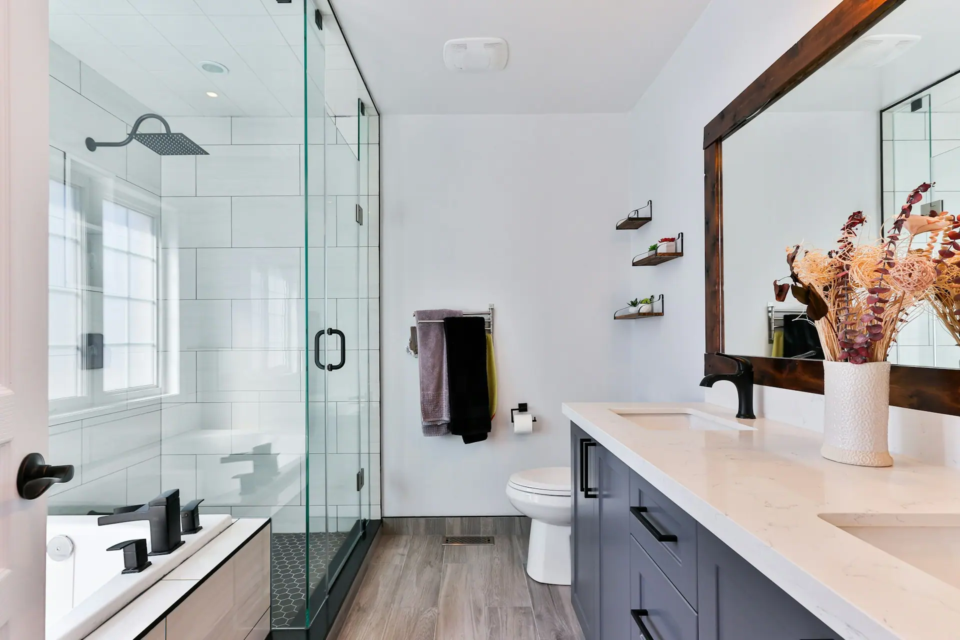 Modern bathroom with glass shower and wall-hung fixtures